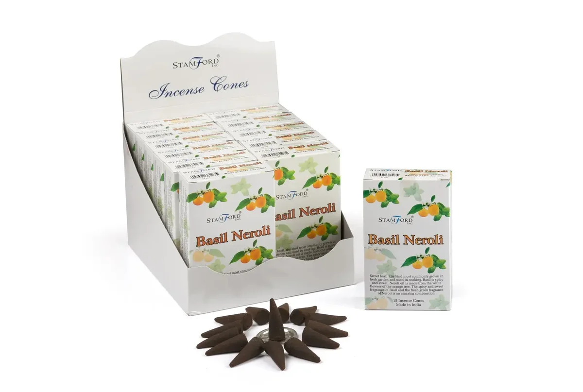 Assorted incense cones basil and neroli arranged flat on white background.