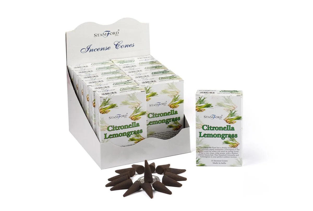 Citronella incense cones displayed on a clear plastic holder, ready for use.