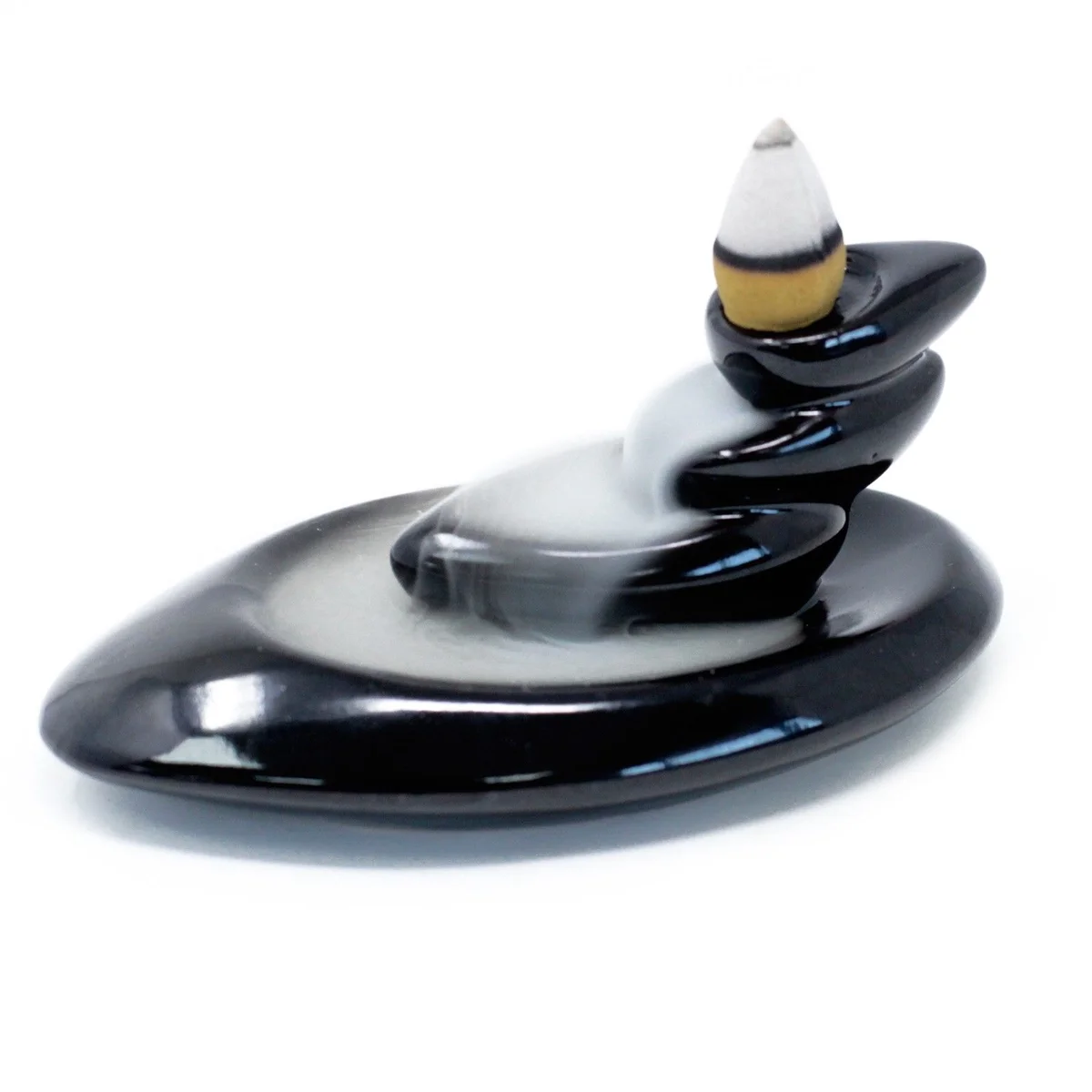 Backflow incense burner featuring small pebbles arrangement.