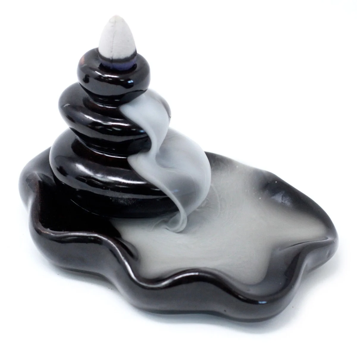 Backflow incense burner with large pebbles in a shallow pool of water.
