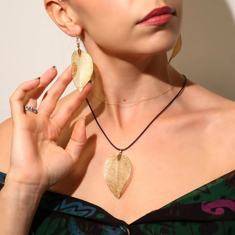Gold jewellery earrings featuring a leaf design