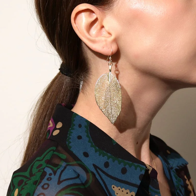 Gold earrings featuring a leaf design