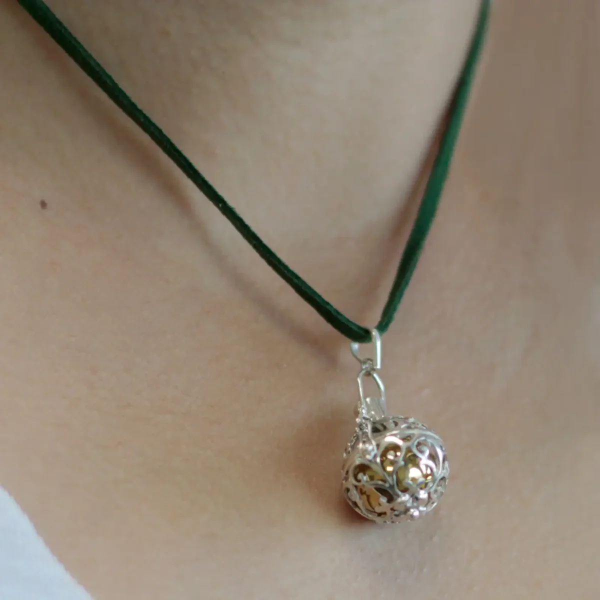 Silver angel bell decor, 18mm, shining on a simple background.