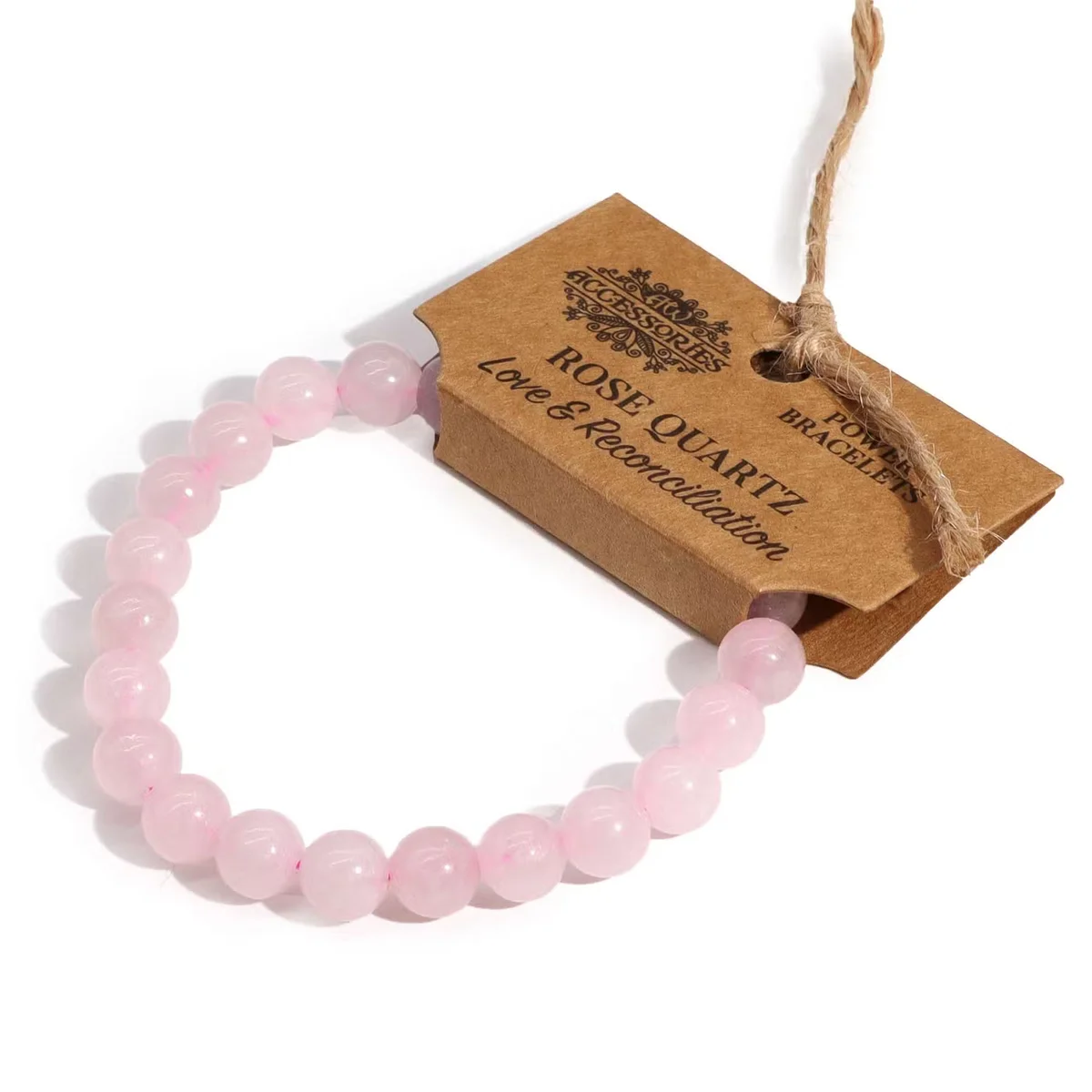Bracelet featuring a rose quartz accessory on a delicate metal link, worn on a wrist.