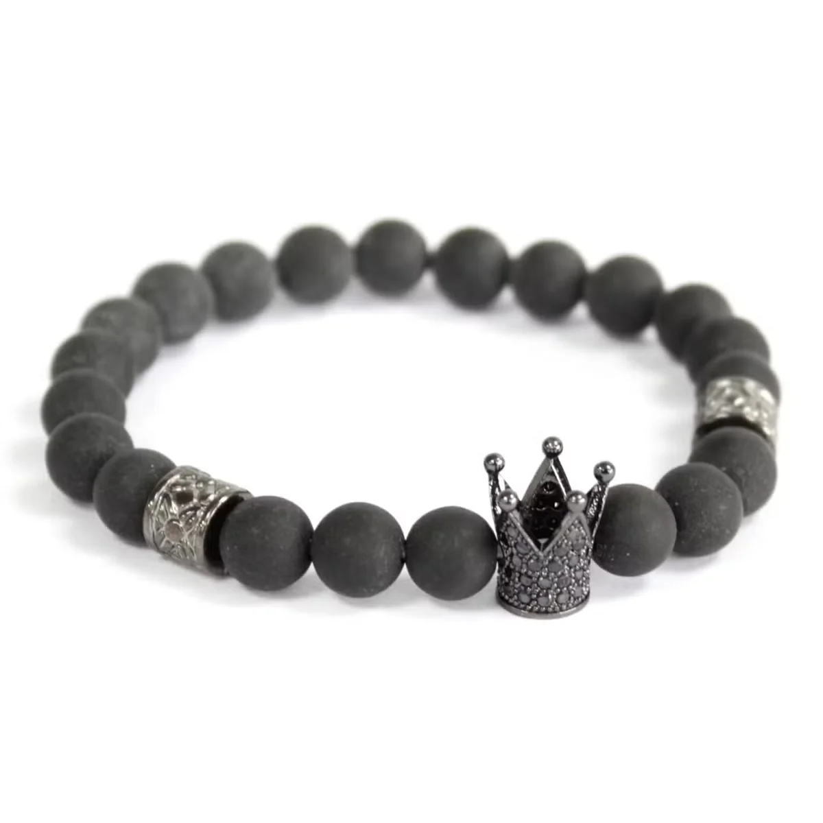 Crystal Crown and black agate gemstones on a gemstone bracelet displayed on a white surface.