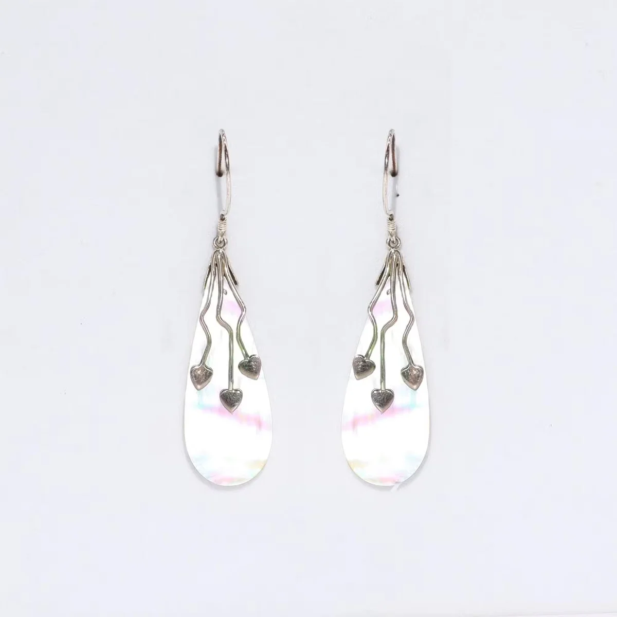 MOP earrings featuring three hearts set in shell and silver.