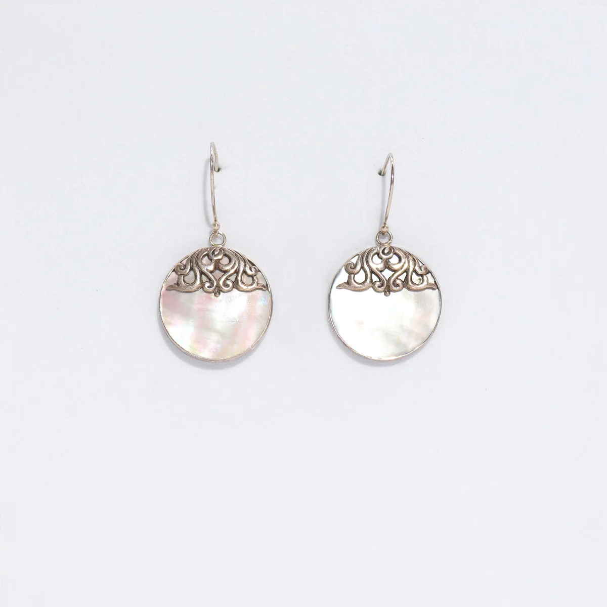 Silver shell earrings, classic disc style.