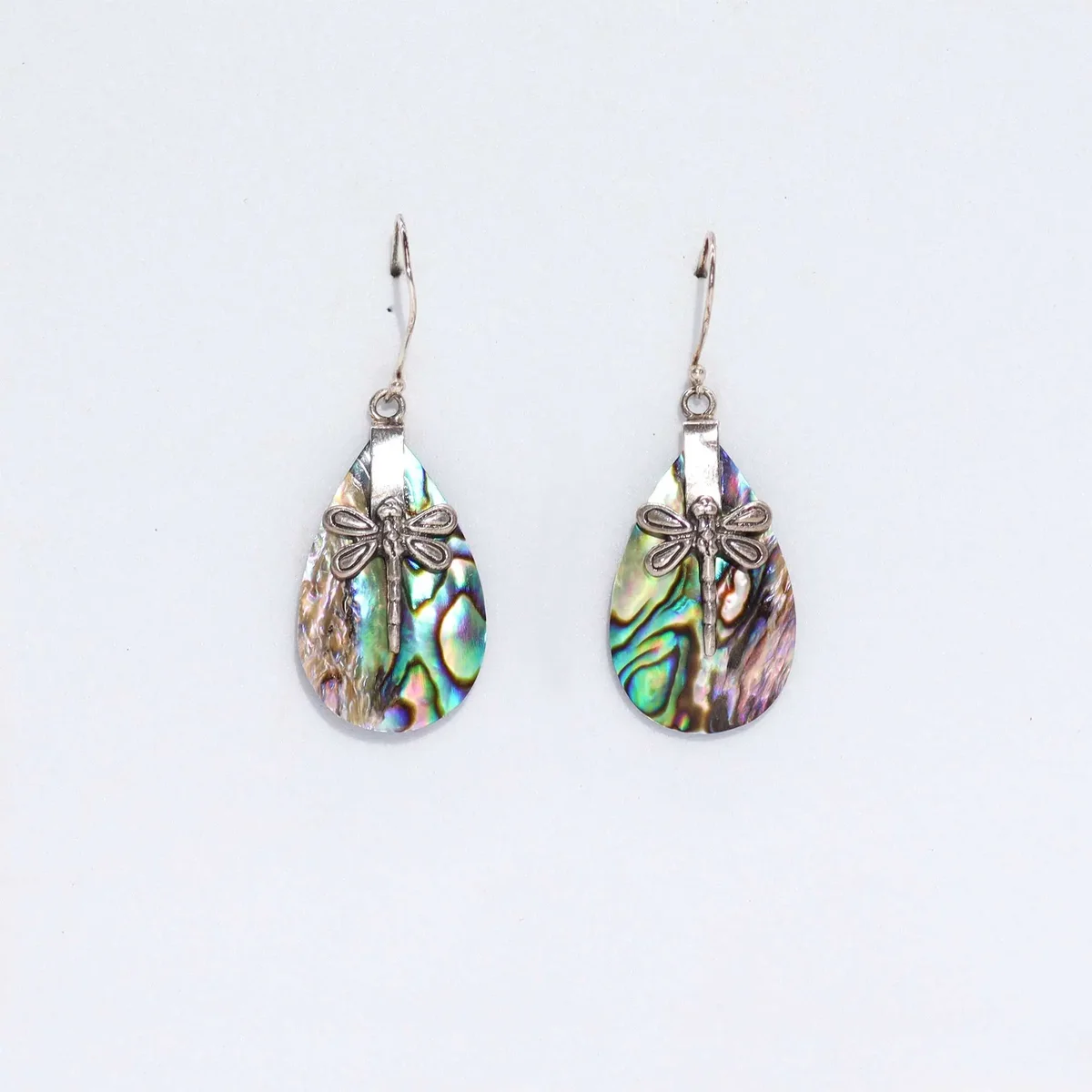 Silver shell earrings featuring dragonfly designs on abalone shells.