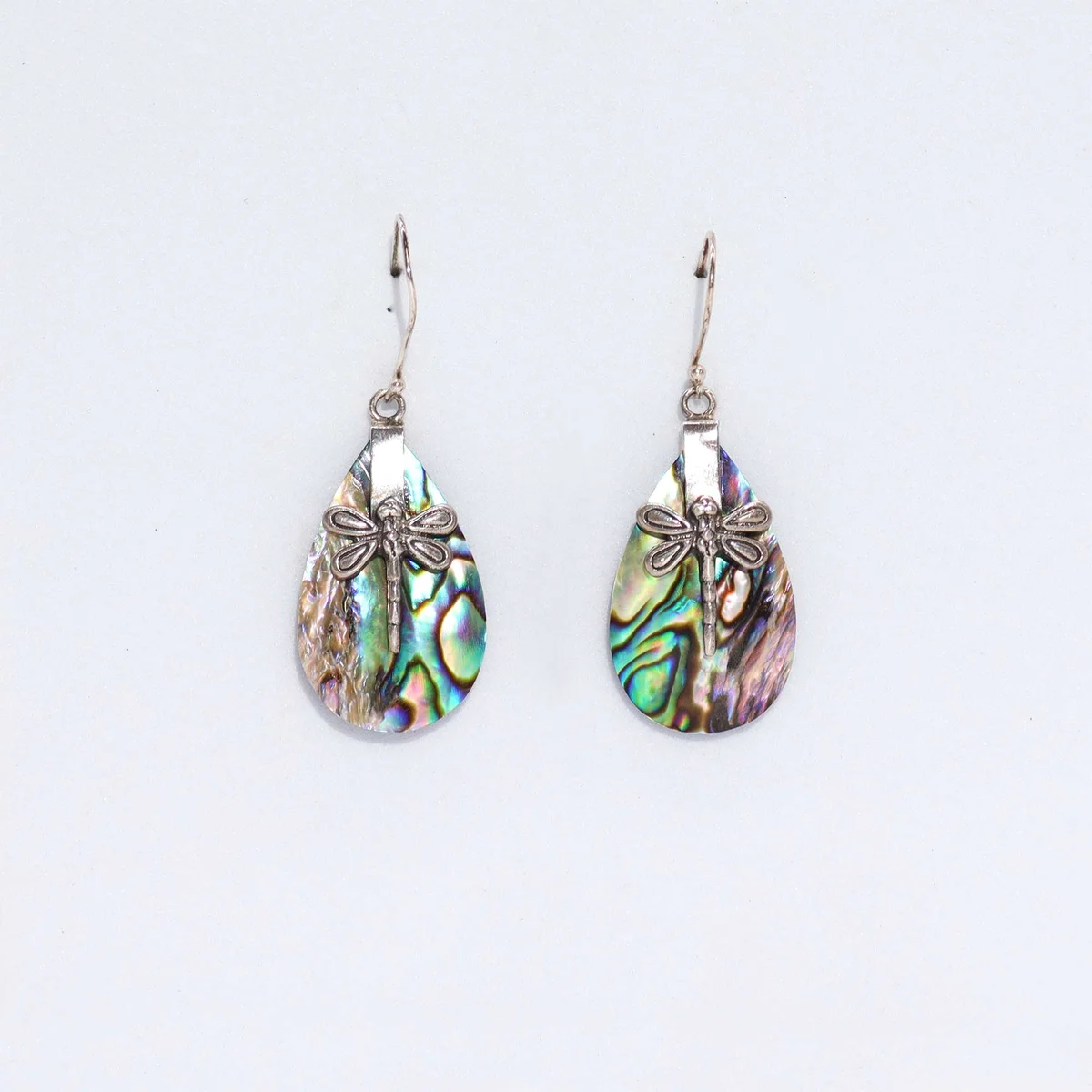 Abalone earrings featuring silver dragonflies on a shell design