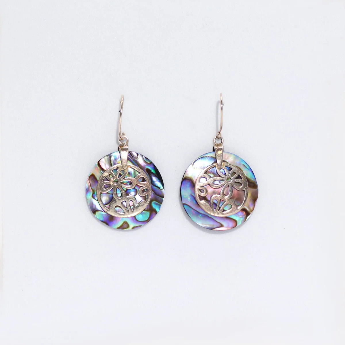 Stylish abalone shell earrings featuring silver flower detailing.