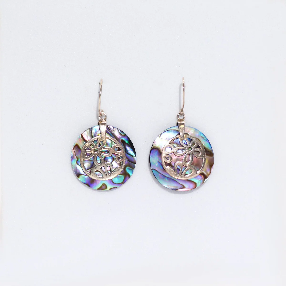 Shell and silver earrings featuring abalone flower design, delicate white shell paired with silver metal.