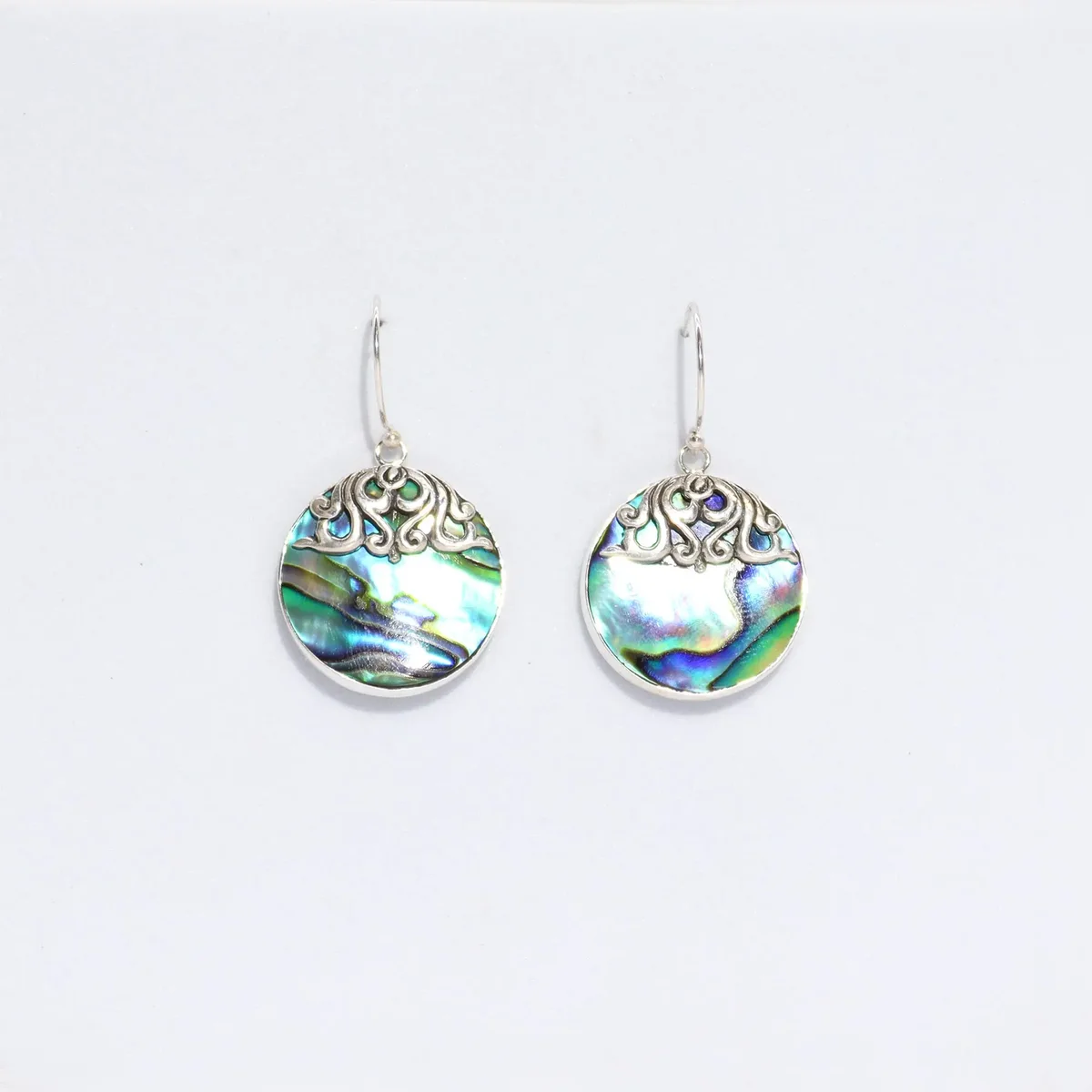 Silver disc earrings with abalone shell centre.