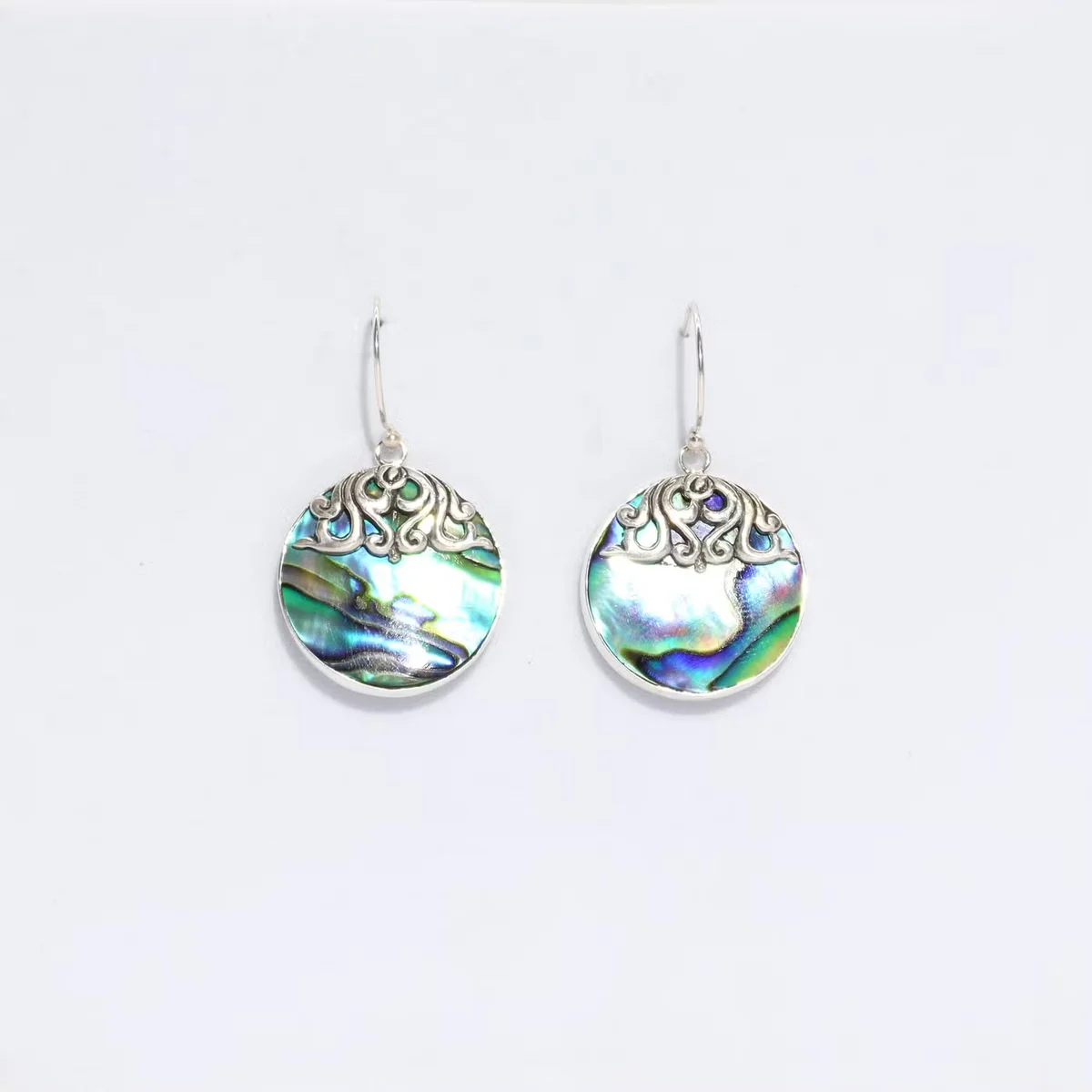 Shell earrings featuring abalone shell in a silver double-disc design.