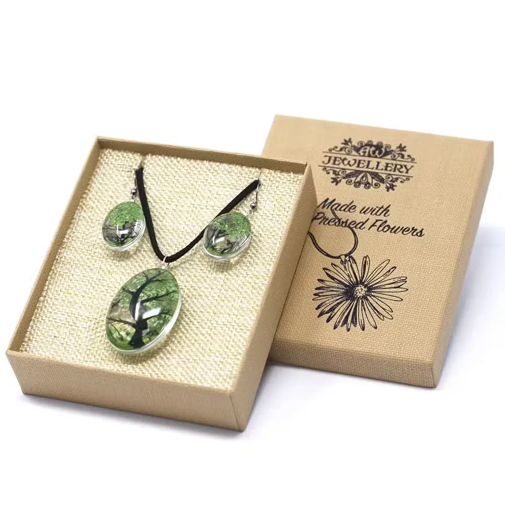 Pressed flower set with green Tree of Life design, arranged on a flat background