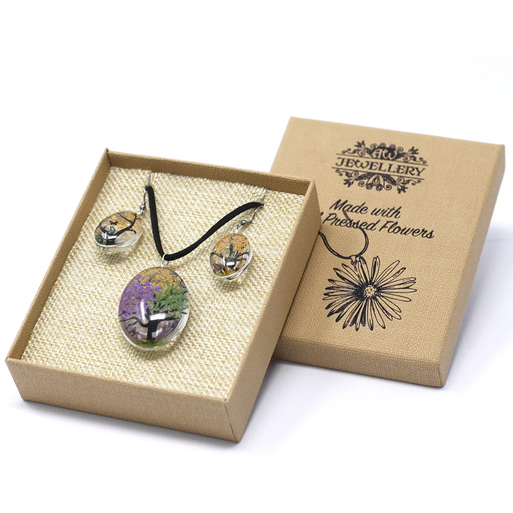 Pressed flowers in a tree of life design with mixed colour pressed flowers in delicate, subtle hues.