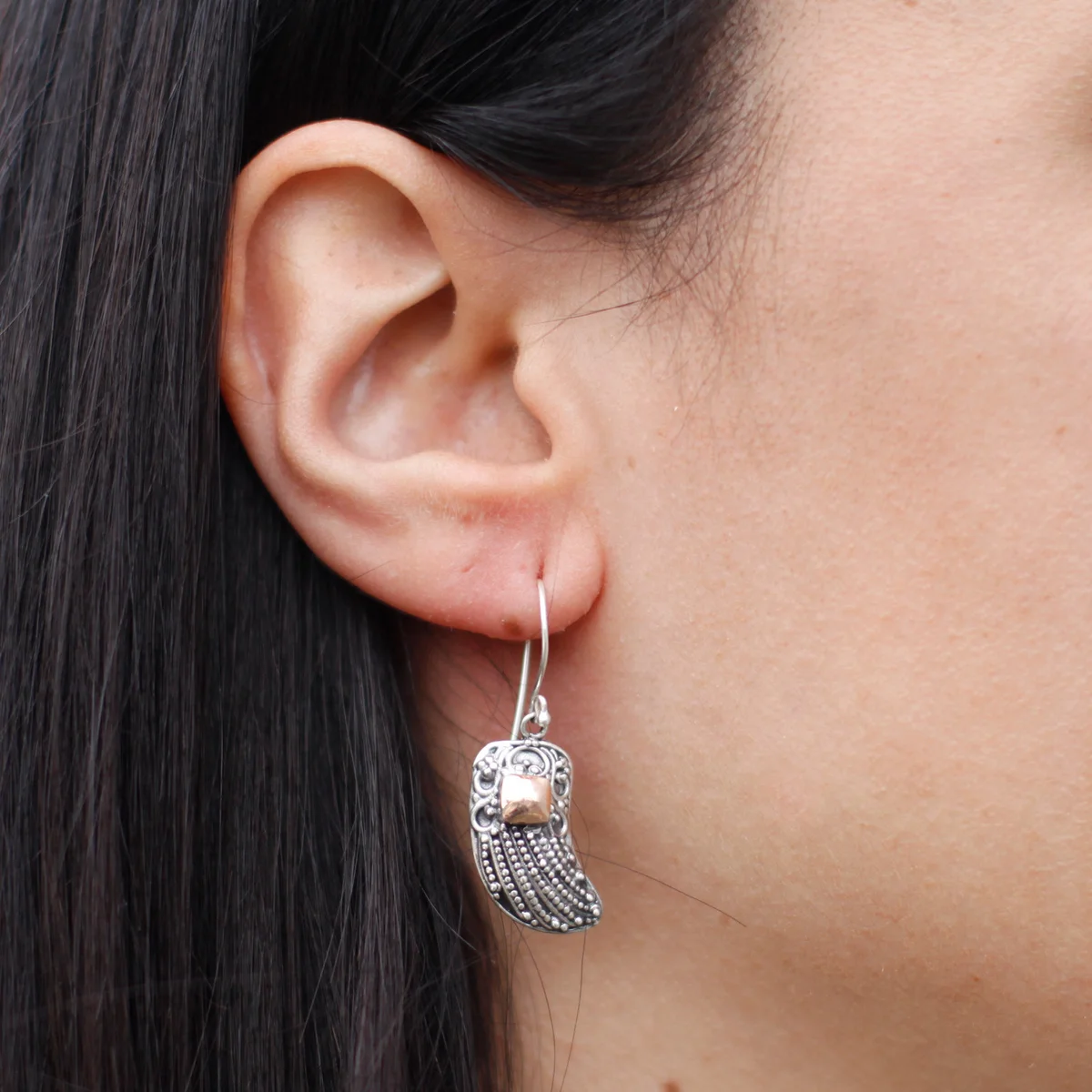 Silver and gold angel wing jewellery earring with delicate wing motifs.