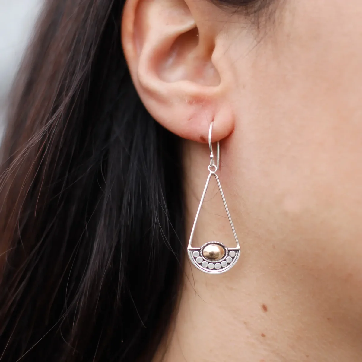 Silver and gold Luna Balance earrings displayed alone on neutral background.