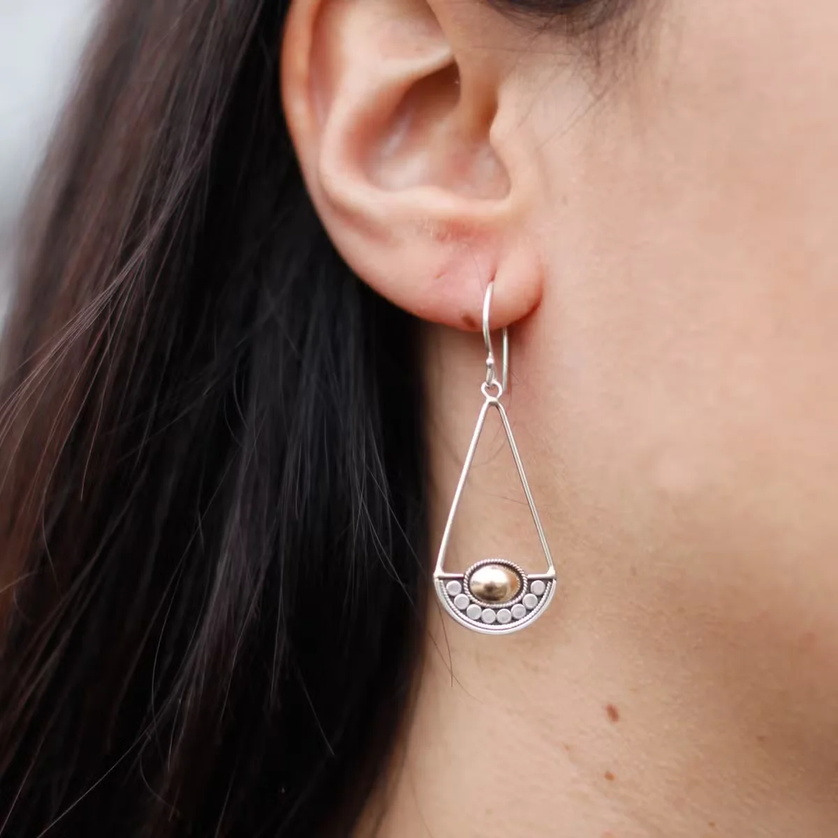 Silver and gold earring shown, balanced design, stylish silver gold jewellery.