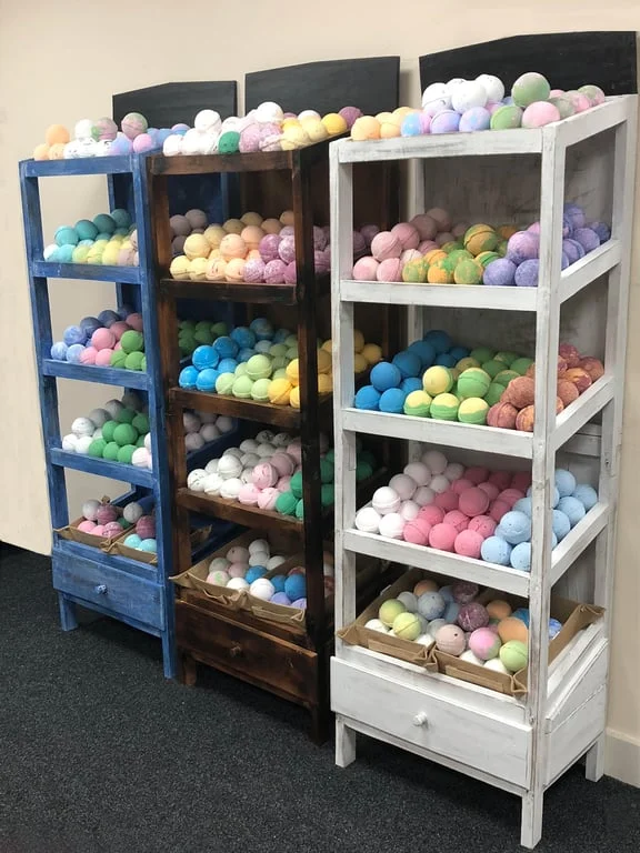 Brownwash bath bomb 5‑shelf display showcasing neatly arranged bath bombs