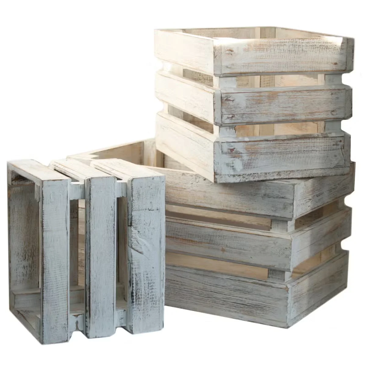 Set of three whitewashed wooden storage crates displayed stacked on a wooden surface.