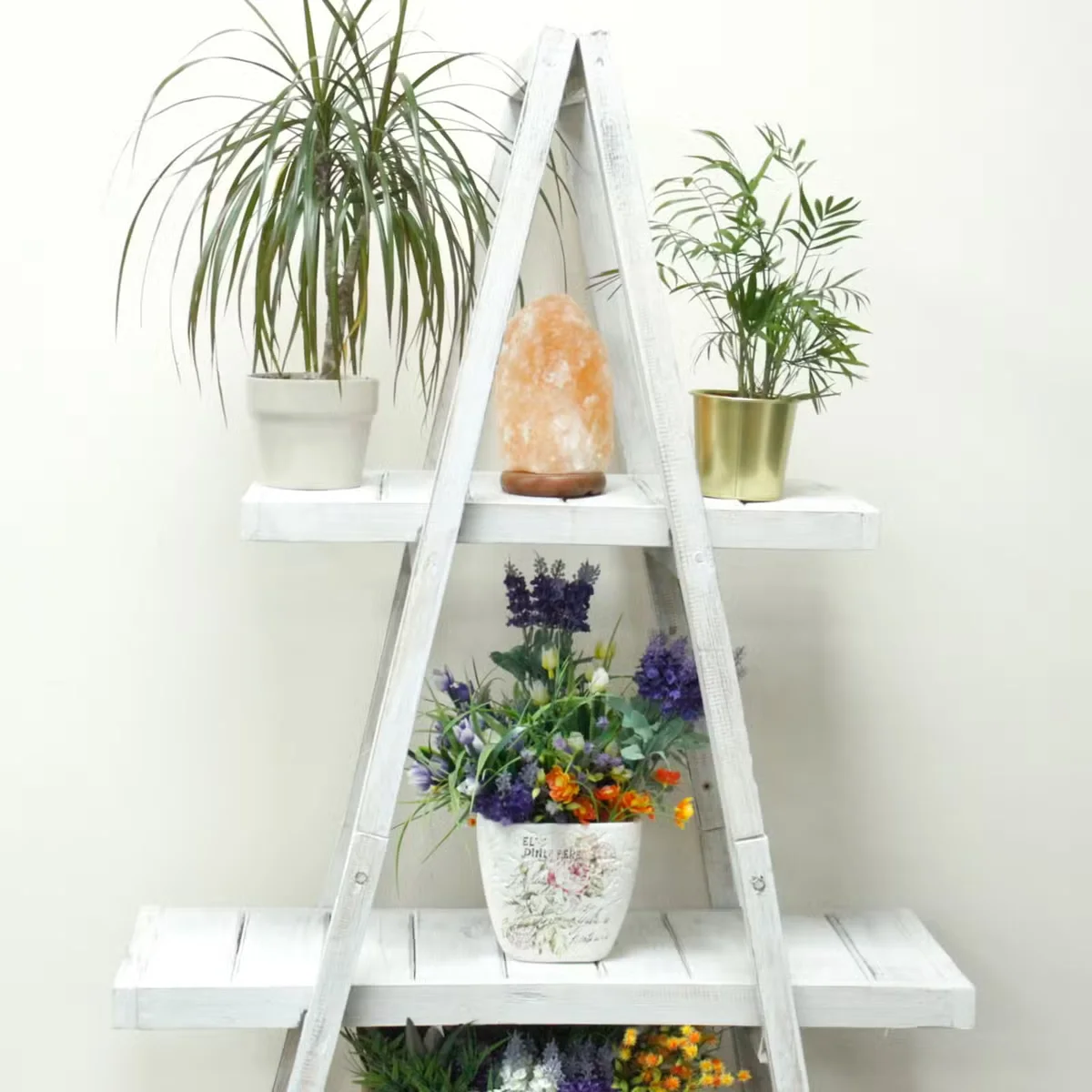 Whitewashed folding wooden A-frame shelf, fully opened with clean sides, a folding storage shelf.