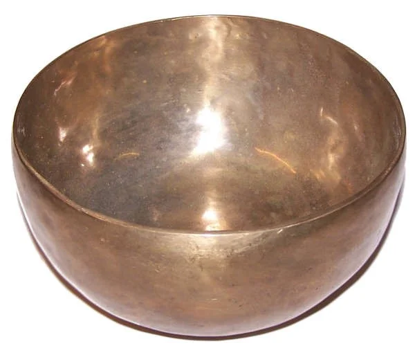 Extra large handmade singing bowl displayed on a wooden surface.