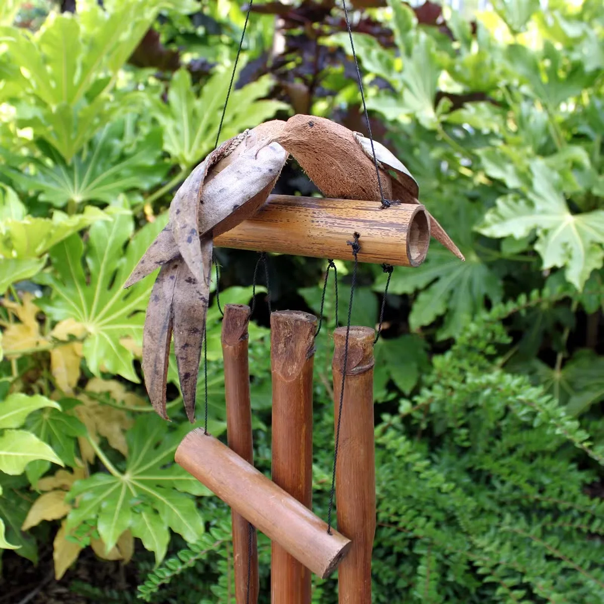 Coconut Twin Birds Windchimes with two bird shapes hanging from a rope above a wooden base