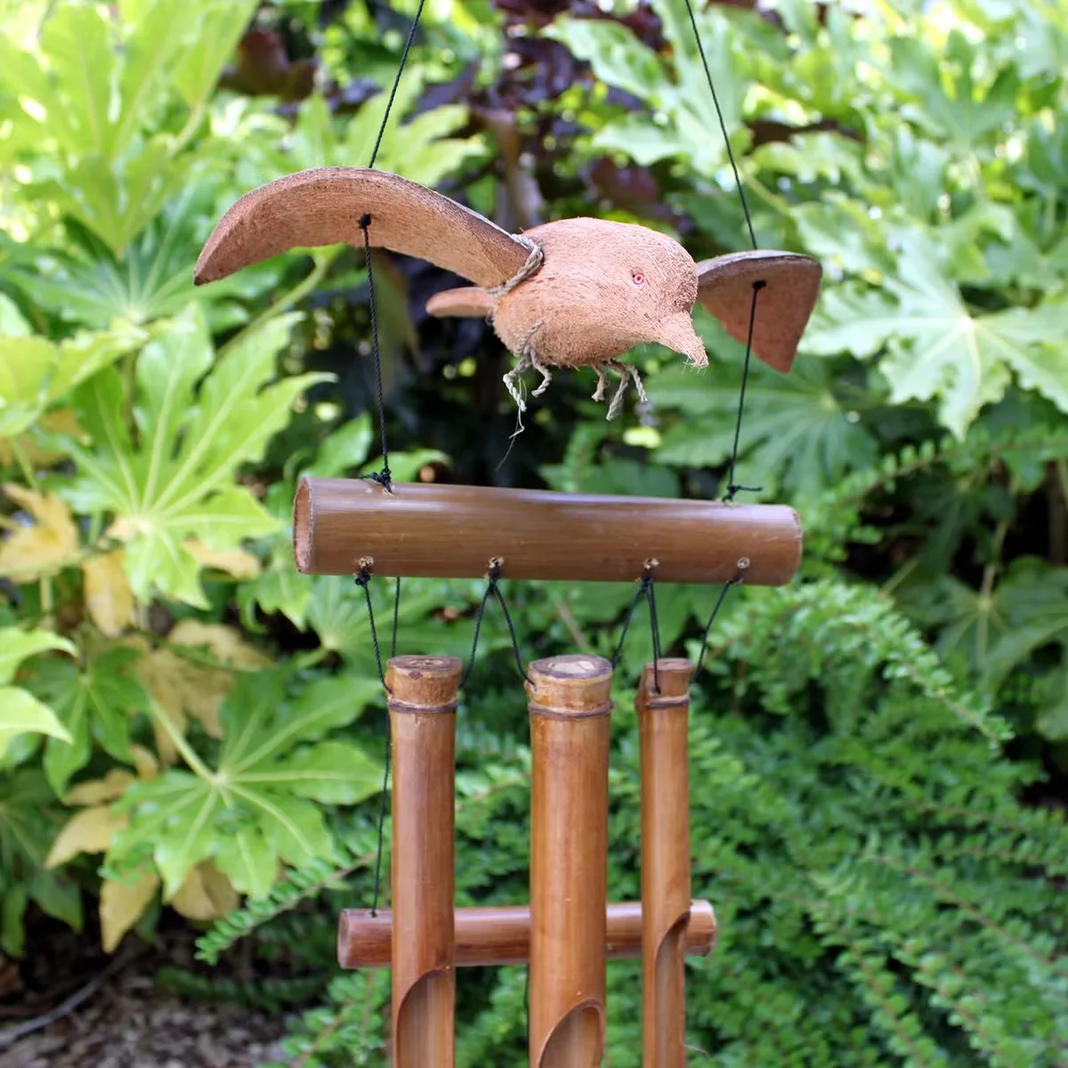 Coconut Blackbird outdoor wind chime, wooden frame with coconut shells and blackbird charms.