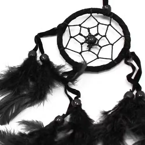 Small round black white red dreamcatcher with woven hoop and colorful threads.