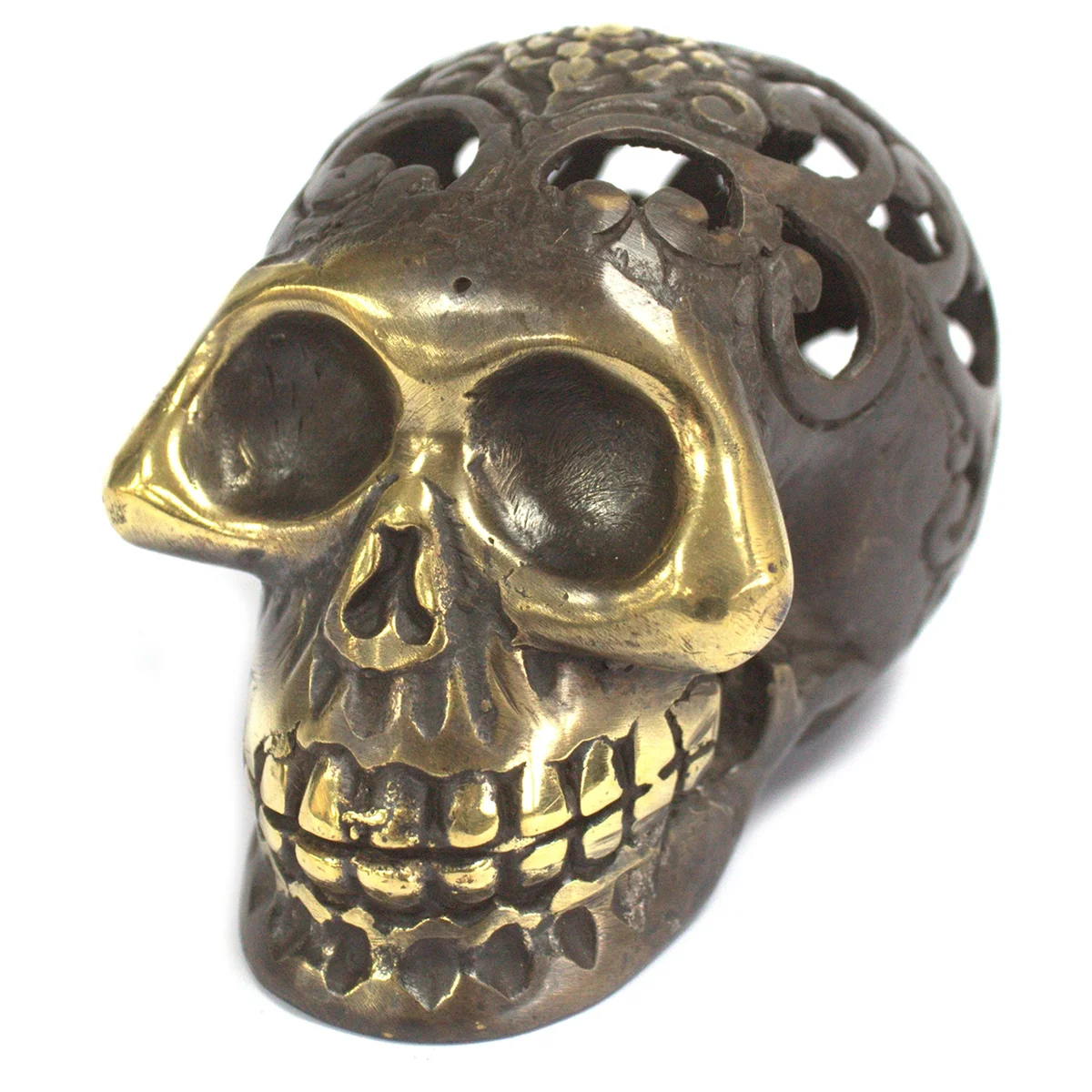 Large vintage brass figurine of a skull featuring intricate ridged detail.