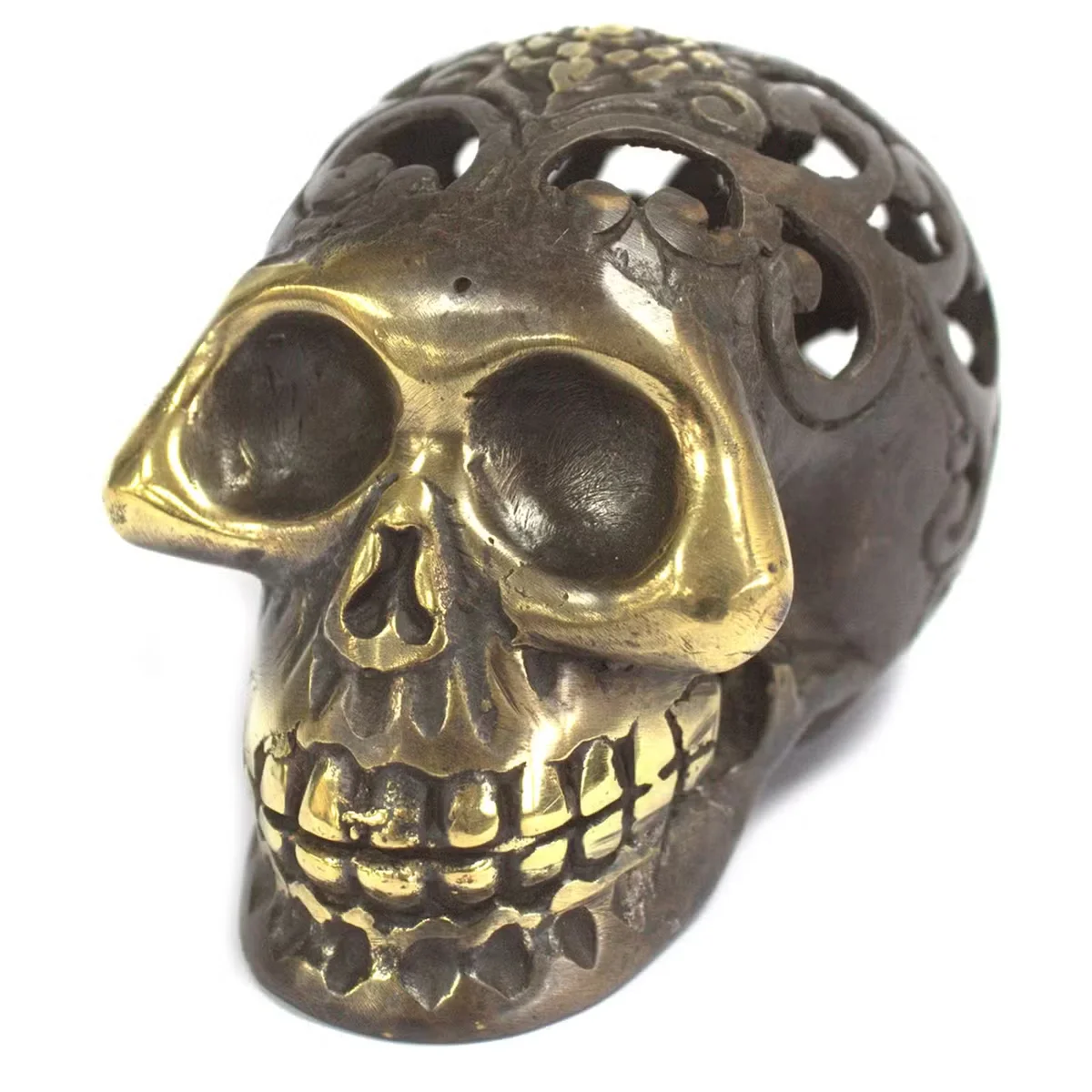 Large skull ornament in rustic brass, detailed bone carving, an ornate vintage skull display.