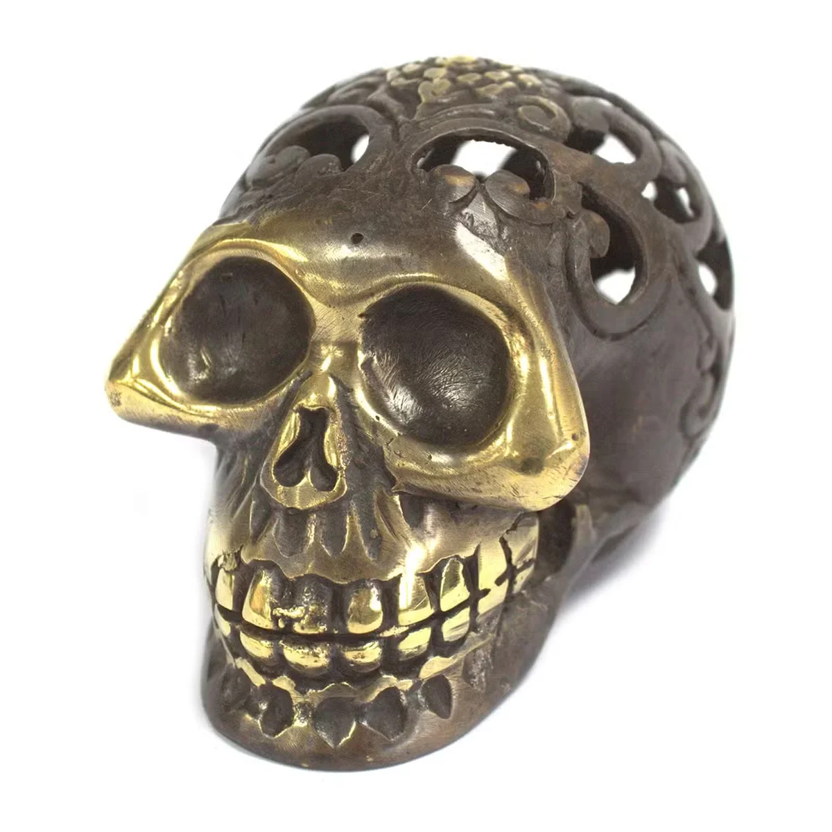 Medium brass skull figurine showing a stylised skull design.
