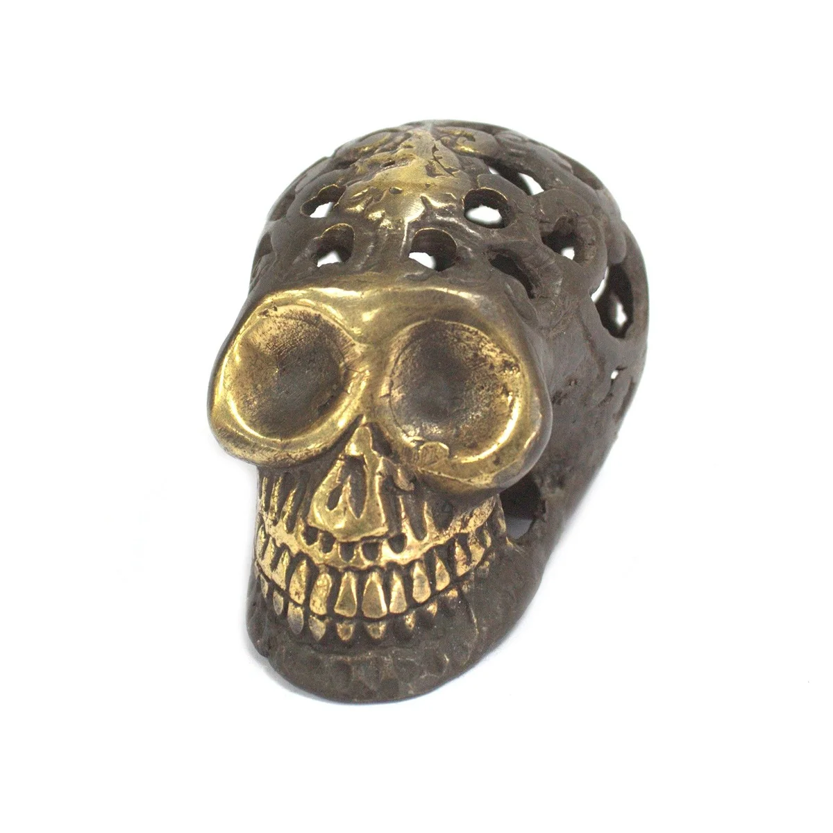 Small vintage brass skull displayed upright on a flat surface.