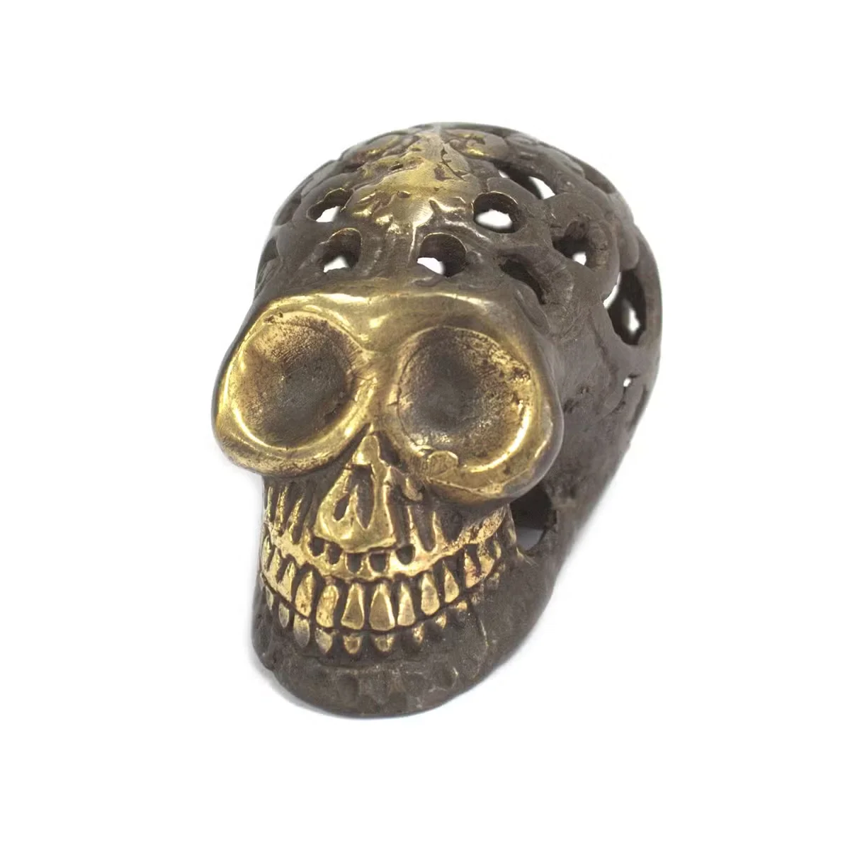 Small vintage brass skull ornament on display