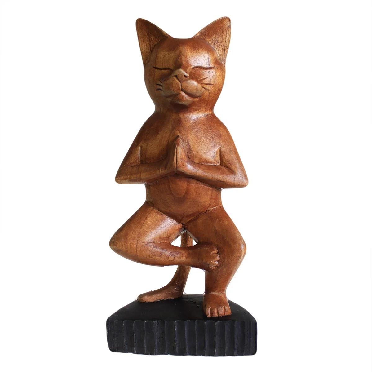 Handcarved cat statue in a yoga pose, balanced on one leg.