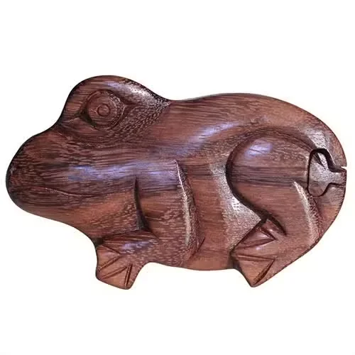 Decorative frog box showcased on natural wood surface, glossy finish, simple background