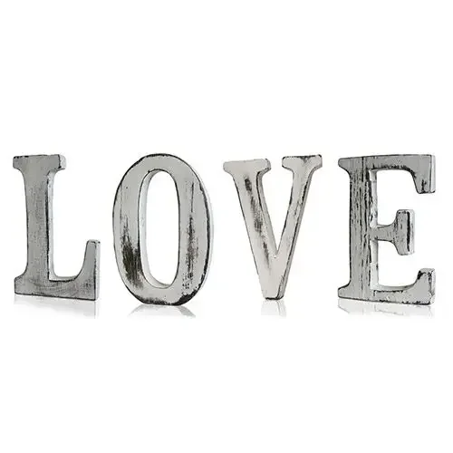 Shabby chic wooden LOVE letters in distressed gold, displayed on a wall as stylish love wall decor.