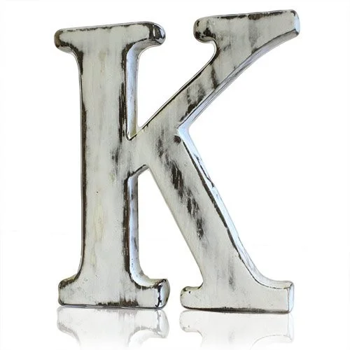 Shabby chic letter K decor on a wooden background.