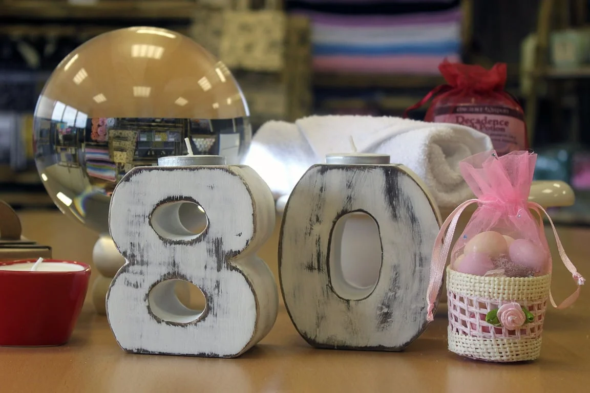 Wooden birthday number 8 displayed against a neutral backdrop.