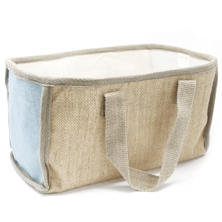 Large teal shopping basket sitting on a kitchen counter, showcasing its bright colour and sizeable dimensions.