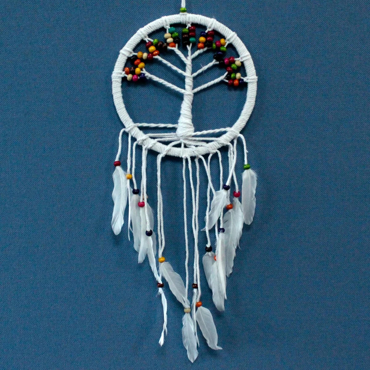 Cotton dreamcatcher in a 22 cm ring, woven with a Tree of Life design and assorted coloured threads.