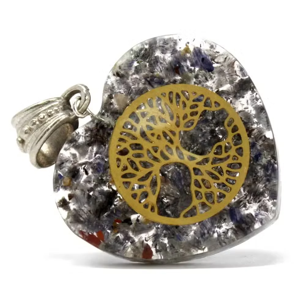 Heart-shaped Orgonite power pendant featuring a tree of life pendant design on black surface