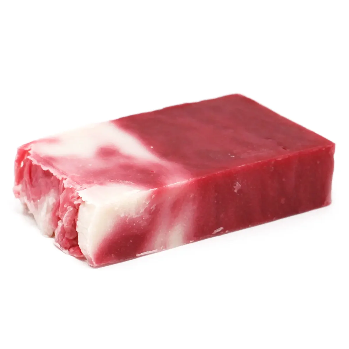 Slice of shea butter olive oil soap about 100g resting on a wooden cutting board.