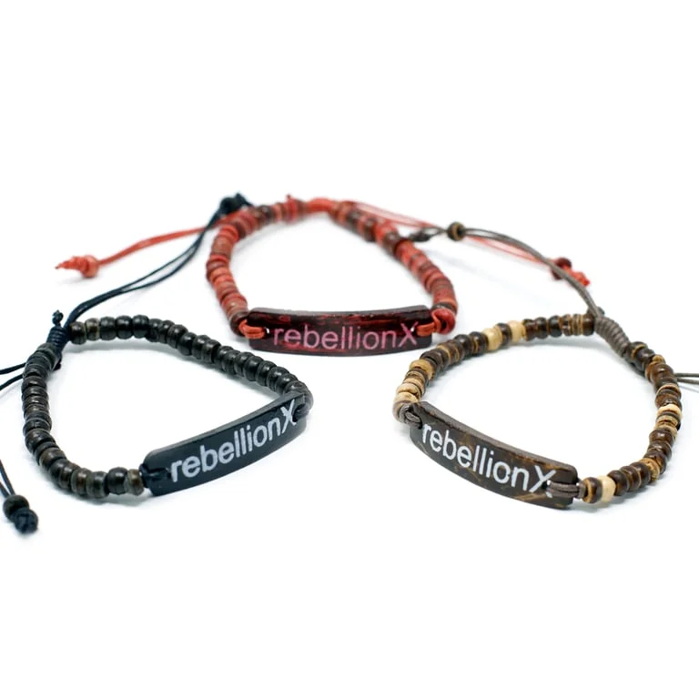 Coco slogan bracelet from Rebellion X displayed on a plain background, showing its simple design and bright finish.