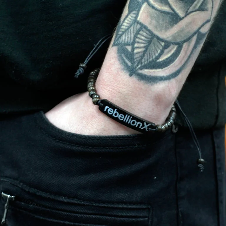 Coco bracelet Rebellion X with bold slogan text on a sleek black bracelet.
