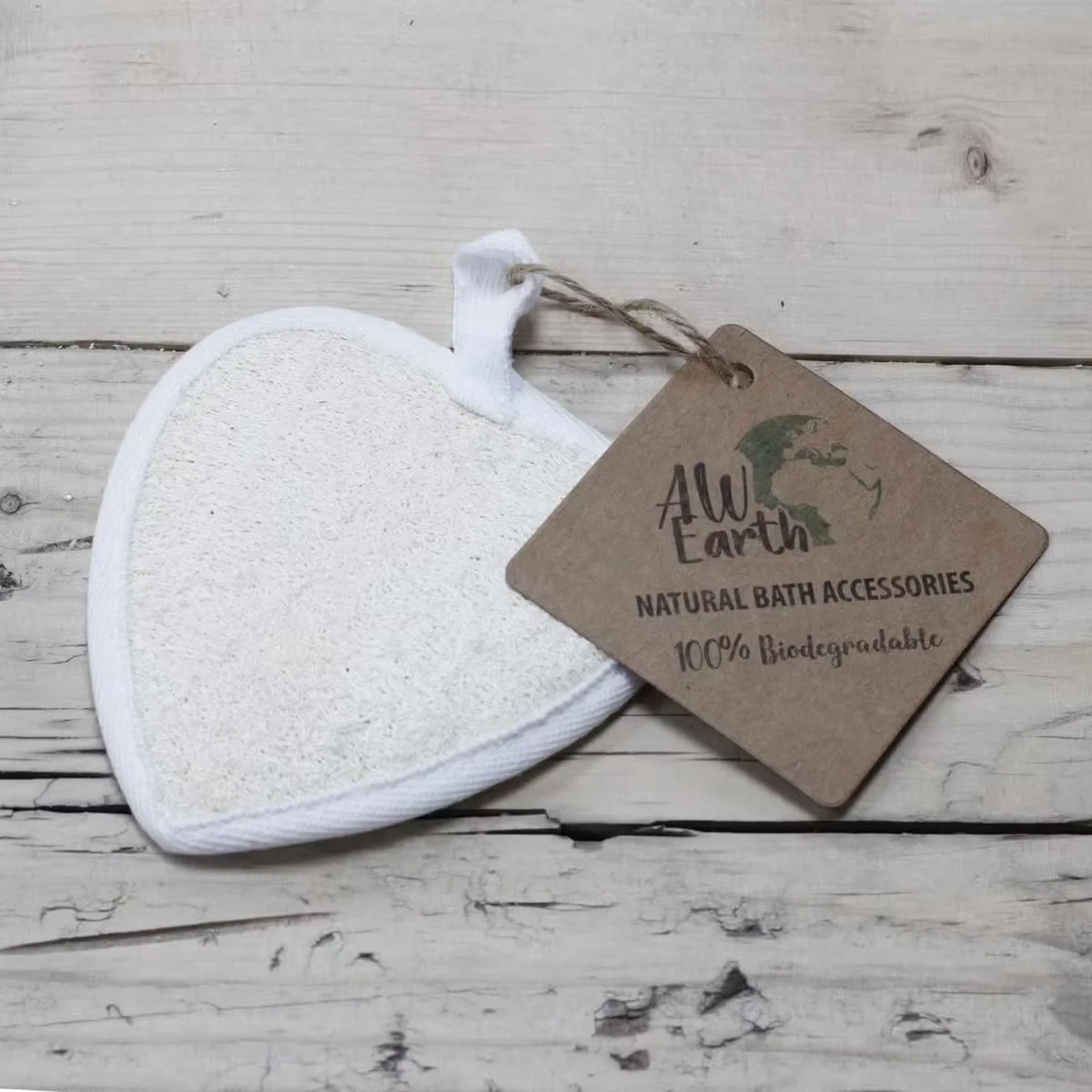 Heart loofah scrub, natural texture, shown in minimalist packaging.