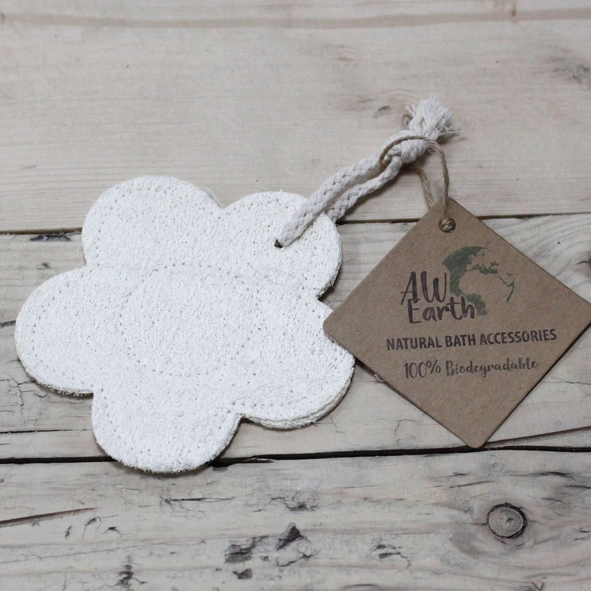 Natural loofah scrub in a flower-themed bottle on a bathroom counter, perfect for a soothing spa routine.