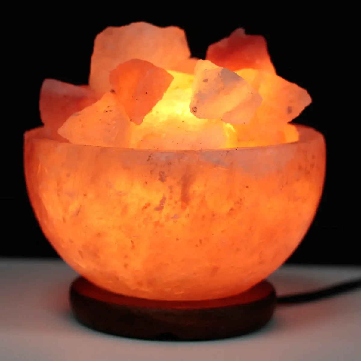 Decorative fire bowl filled with salt chunks measuring 15cm by 9cm on a plain background