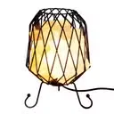 Mesh basket holding white salt chunks, a power cable and a lamp bulb, forming a salt lamp with bulb.