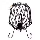 Mesh industrial iron cable lamp with exposed bulb suspended above a dark metal base